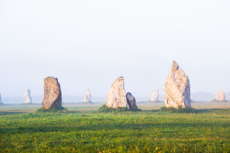 Menhir alignment view at Camaret sur mer at sunrise. Strong morning fog. Brittany, Franceの写真素材