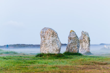 Menhir alignment view at Camaret sur mer at sunrise. Strong morning fog. Brittany, Franceの写真素材