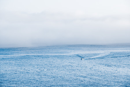 Low morning fog over ocean waves in Brittany, Franceの写真素材