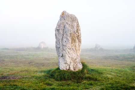 Menhir alignment view at Camaret sur mer at sunrise. Strong morning fog. Brittany, Franceの写真素材