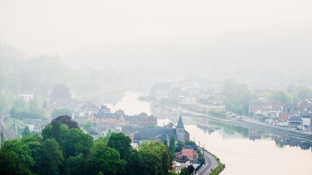 Aerial view of a small town Dinant, Belgium, on a cloudy dayの写真素材