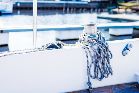 White yacht on the pier. Close-up of the mast winch and ropes. Port of Riga, Latvia