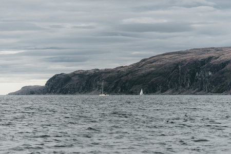 Sailing near the rocky shores (cliffs) of the west coast of Jura island, a view from the yacht....