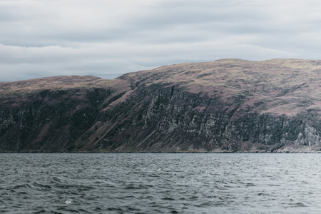 Sailing near the rocky shores (cliffs) of the west coast of Jura island, a view from the yacht....
