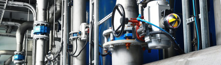 Large industrial water treatment and boiler room. Piping, valves, flanges. Industry, technology, special equipment, chemistry, environment, heating, work safety. Panoramic viewの写真素材