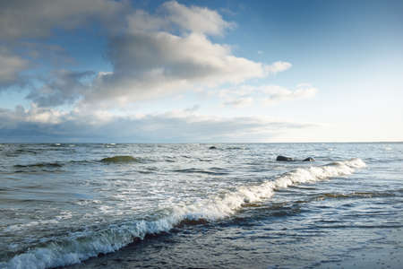 Panoramic view of the Baltic sea in winter. Clear blue sky with glowing cumulus clouds. Water...