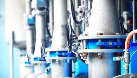 Large industrial water treatment and boiler room. Piping, flanges, butterlfy valves, rusty and...
