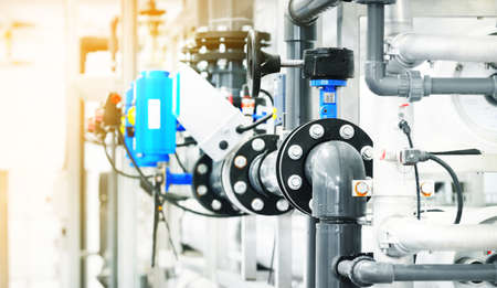 Large industrial water treatment and boiler room. Plastic and metal pipes with armature, valves