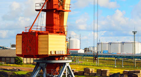Port crane in oil terminal, close-up. Ventspils, Latvia, Baltic sea, Europe. Freight transportation,...