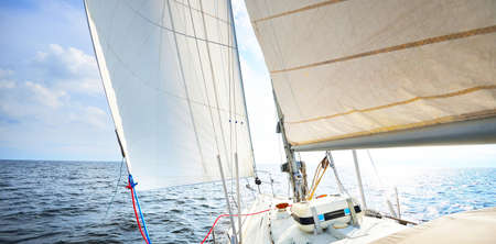 View forward from a yacht tilted from the wind. Clear blue sky. Transportation, nautical vessel,...