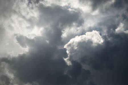 Epic cloudscape. White ornamental cumulus clouds before the rain. Fickle weather, sun rays. Baltic sea. Natural pattern, texture, background, wallpaper, 3D, graphic resources, design, copy spaceの写真素材