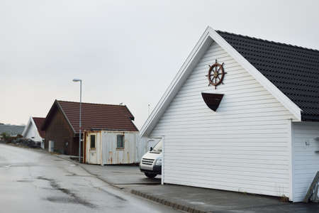 Panoramic view of the empty street near yacht marina, modern traditional white wooden house,...