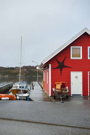 Panoramic view of the empty street near yacht marina, modern traditional house with tiled roof, falu...