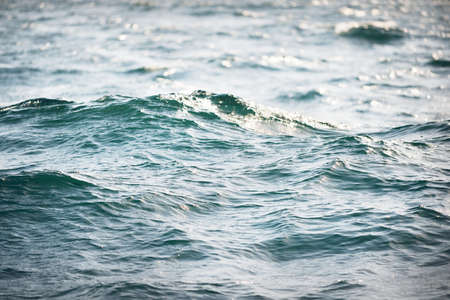 High angle view of the Mediterranean sea. Waves, splashes, water surface texture. Blue, azure, turquoise colors. Abstract natural pattern, background, wallpaper. Graphic resources, copy spaceの写真素材