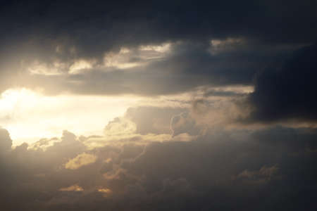 Clear blue sky with glowing white cumulus clouds after thunderstorm. Dramatic sunset cloudscape....