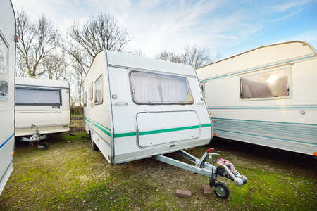 Caravan trailers parked on a green lawn. Winter. Local business, company, service concept....