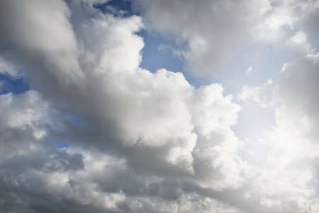 Clear blue sky with glowing white cumulus clouds after the storm. Dramatic sunset cloudscape. Concept art, meteorology, weather, heaven, hope, peace, graphic resources, picturesque panoramic sceneryの写真素材