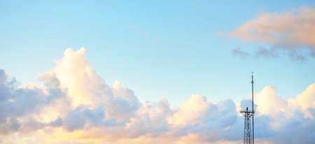 Clear blue sky with glowing pink and golden cumulus clouds after storm at sunset. Dramatic...