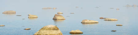 Rocks at the coast of Kasmu (captain's village), Estonia, in a white fog at sunset. Baltic sea. Soft...