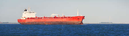 Cargo tanker ship sailing in a blue sea. Vlissingen, the Netherlands. Freight transportation, fuel and power generation, nautical vessel, logistics, industry, environment. Panoramic view, copy spaceの写真素材