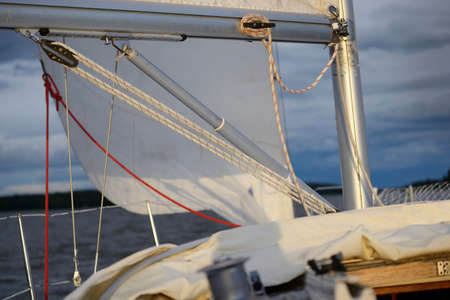White yacht sailing at sunset. View of the deck, mast, bow. 32 feet swedish built cruising sailboat....