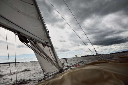 White yacht sailing during the storm. View of the mast, sails, rigging equipment. 32 feet swedish...