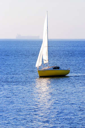 yellow sail yacht sailing. Riga, Latviaの写真素材