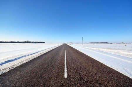 classic winter scene of a highway in rural area