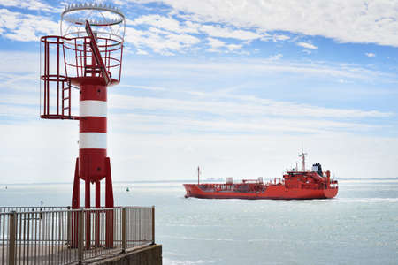 Red cargo ship (tanker) is sailing near Vlissingen, the Netherlandsの写真素材