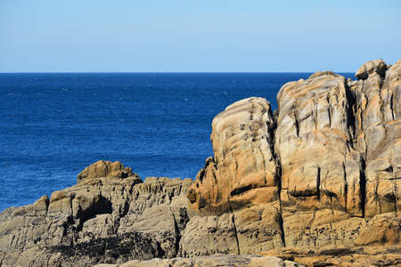 Large sandstone cliffs on French coast in Brittany, Bretagne