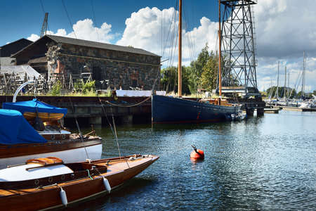 Small haven with moored yachts and a crane in Helsinki