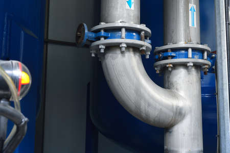 Large industrial water treatment and boiler room. Shiny steel metal pipes and blue pumps and valves.の写真素材