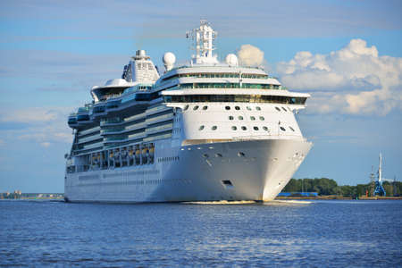 Big cruise ship leaving port of Rige on a sunny summer dayの写真素材