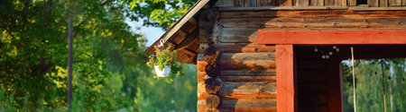 An old traditional rustic wooden house (log cabin or shed) in a green birch tree forest. Pastoral landscape. Garden equipment in the background. Eco tourism, recreation theme. Setomaa, Estoniaの写真素材