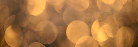 Abstract colorful golden bokeh background, pattern, texture, wallpaper, panoramic concept image. Design, graphic resources, 3D, copy space. Brown, orange, yellow colorsの写真素材