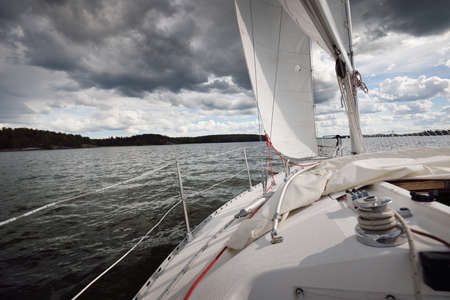 White yacht sailing after the storm. View of the mast, sails, rigging equipment. 32 feet swedish...