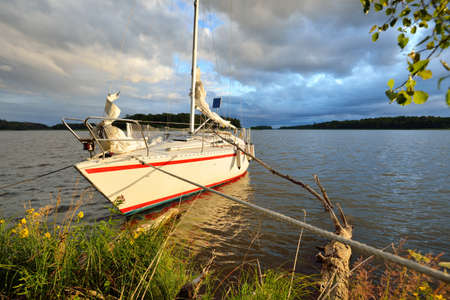 Yacht anchored to the rocky shore. 32 feet swedish built cruising sailboat. RidÃ¶n island, lake...