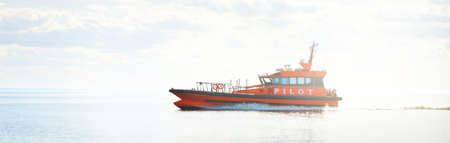 Large cargo container ship sailing in an open Baltic sea on a clear day. Freight transportation,...
