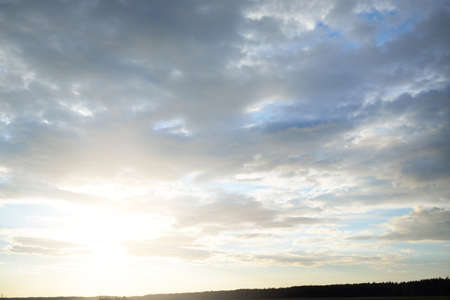 Panoramic view of the green forest at sunset. Dramatic sky, glowing clouds. Idyllic summer rural scene. Nature, ecology, ecotourism, remote placesの写真素材