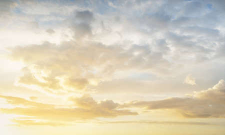 Clear blue sky. glowing pink and golden cirrus and cumulus clouds after storm, soft sunlight. Dramatic sunset cloudscape. Meteorology, heaven, peace, graphic resources, picturesque panoramic sceneryの写真素材
