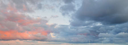 Clear blue sky, pink and golden cirrus and cumulus clouds after storm at sunset. Dramatic...