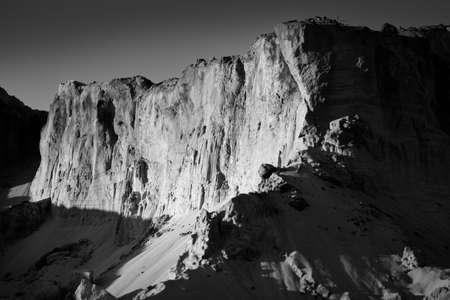 Panoramic view of the red sandstone canyon (quarry). Atmospheric black and white landscape. Travel...