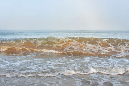 Panoramic view from the Baltic sea shore in a fog at sunrise. Waves, splashes, water surface. Soft...