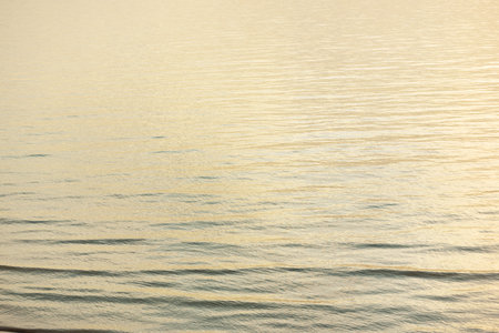 Baltic sea shore (sand dunes) at sunset. Clear blue sky and golden sunlight, reflections in a still water. Abstract natural pattern, texture, background, seascape, concept image, graphic resourcesの写真素材