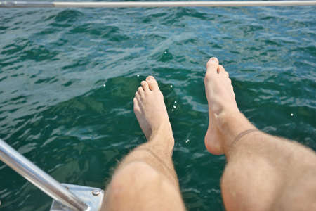 Man chilling in a sailboat. Turquoise water, open sea. Old expensive classic yacht. Freedom,...