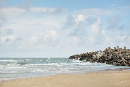 Baltic sea shore (sand dunes, beach) after the storm. Dramatic sky, glowing clouds. Promenade to the...