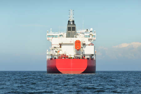 Large red cargo ship (oil chemical tanker, 184 meters length) sailing in the Baltic sea. Freight transportation, logistics, global communications, economy, industry, supply, environmentの写真素材