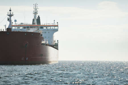 Large red cargo ship (oil chemical tanker, 184 meters length) sailing in the Baltic sea. Freight transportation, logistics, global communications, economy, industry, supply, environmentの写真素材