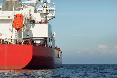 Large red cargo ship (oil chemical tanker, 184 meters length) sailing in the Baltic sea. Freight transportation, logistics, global communications, economy, industry, supply, environmentの写真素材