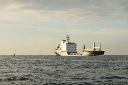 General cargo ship (98 meters length) sailing in the Baltic sea. Freight transportation, logistics, global communications, economy, industry, supply, environmentの写真素材